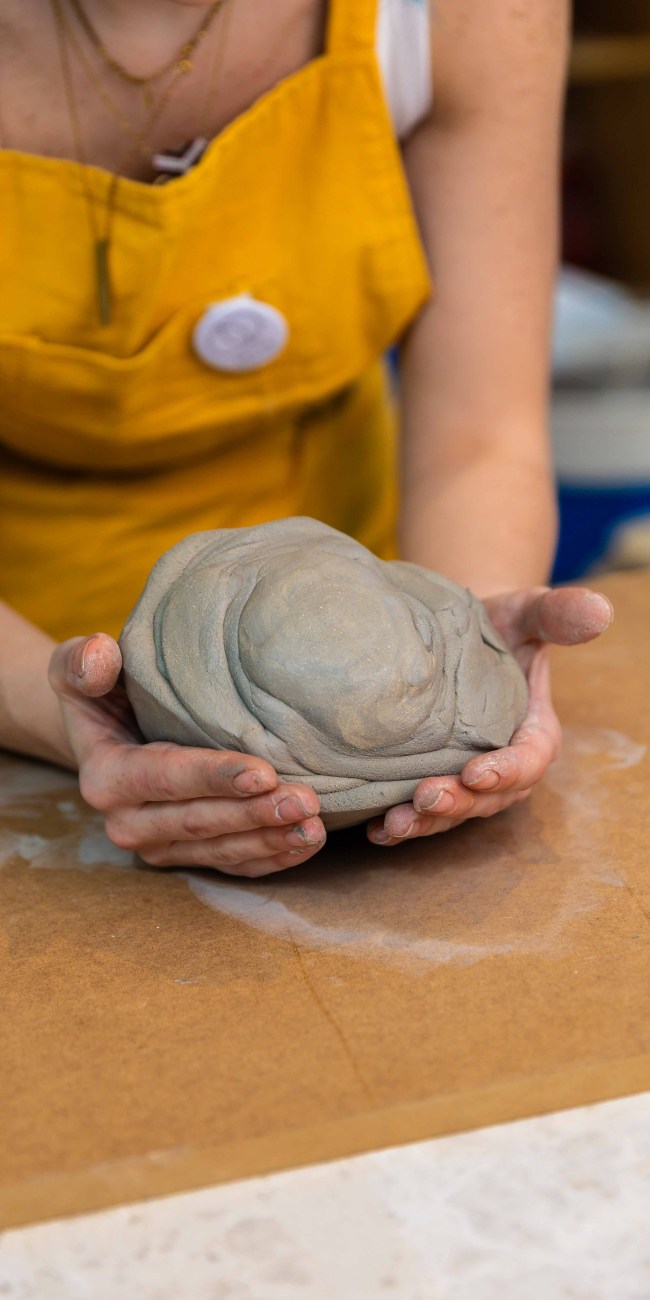 A woman wedging clay at Zolta Ceramic Studio Vienna
