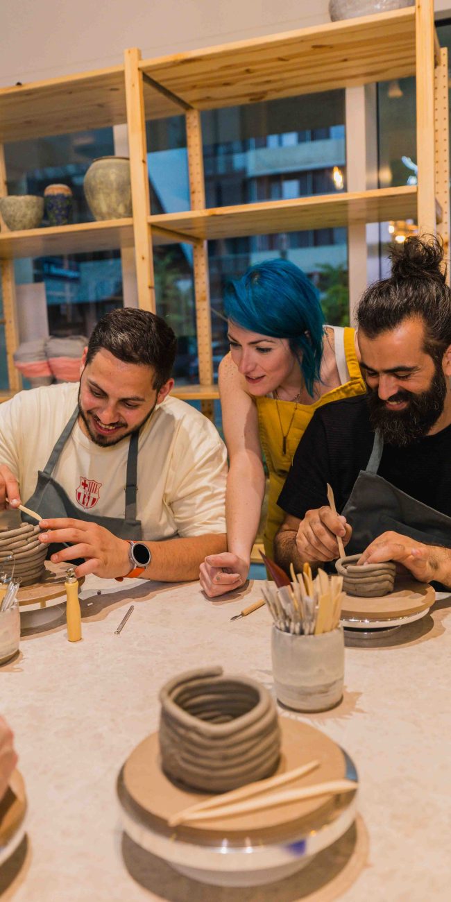 two men and a ceramic artist in a ceramic hand-built workshop at Zolta Ceramics Studio, Vienna