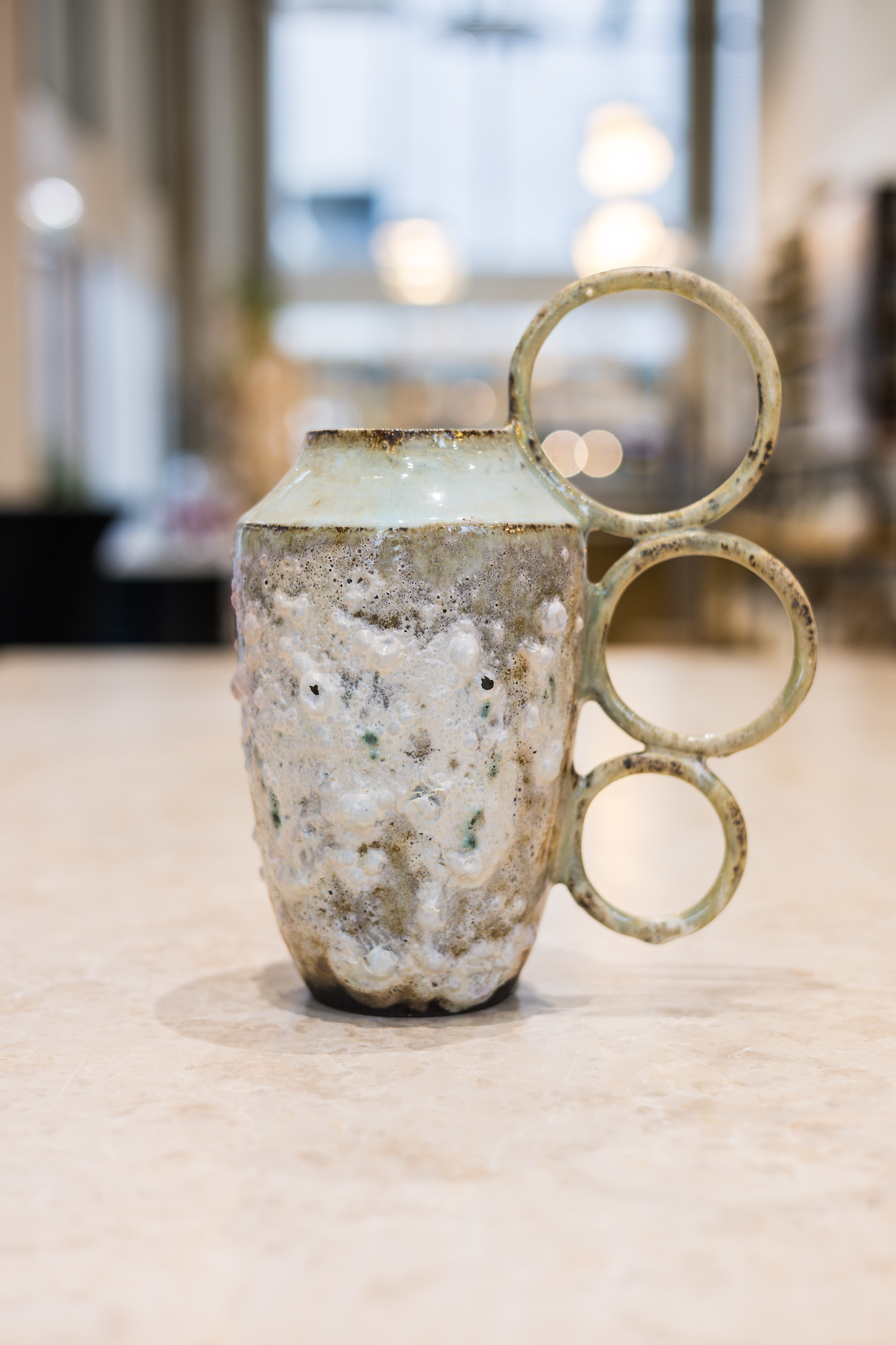 Sirin AlMasri Ceramic artwork vase with three earrings at Zolta Ceramics Studio Vienna