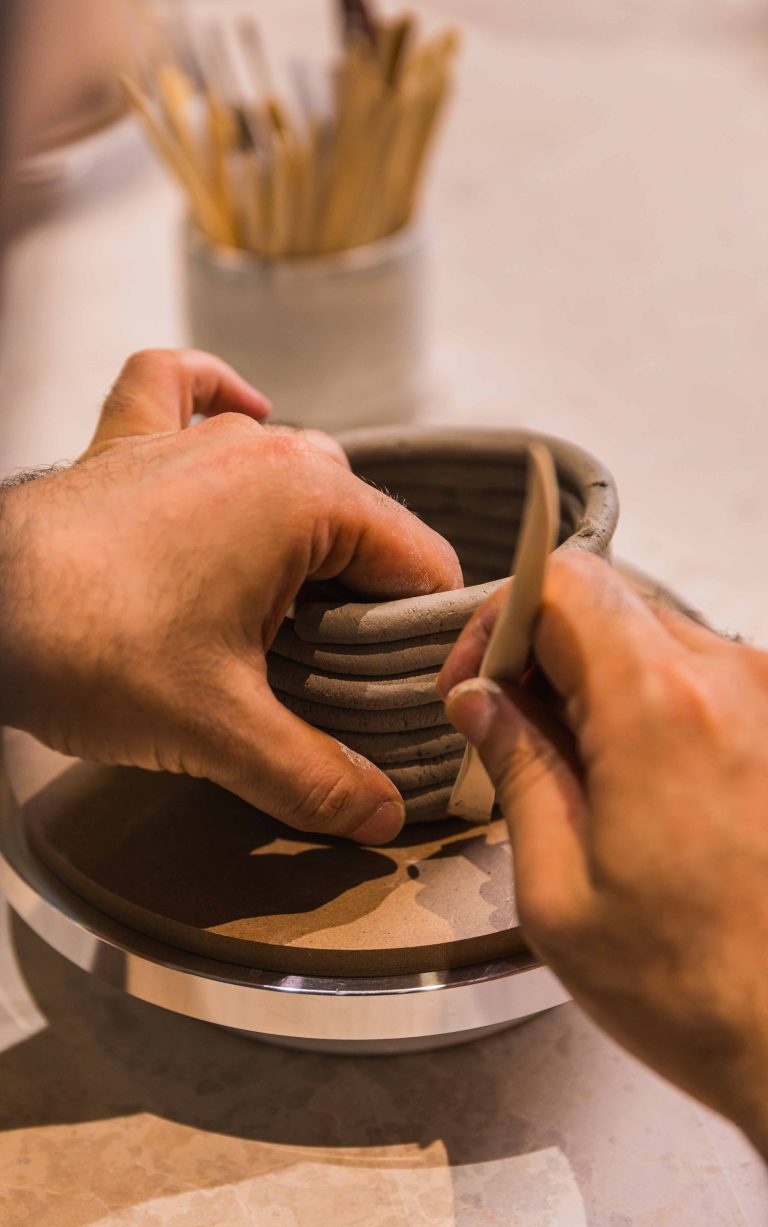 man making ceramic with coils in Zolta ceramics studio Vienna