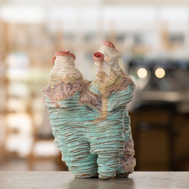 Stoneware sculpture Splitting Core by Sirin AlMasri at Zolta Ceramics Studio, featuring layered, canyon-like forms with turquoise and earthy glazes and organic vertical ridges suggesting geological movement. Ceramic Hand-building: Vase Making