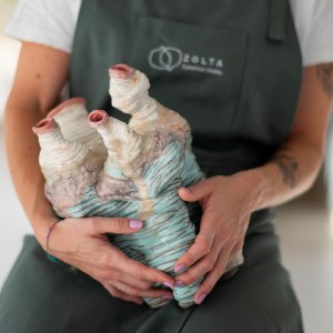 Stoneware sculpture Splitting Core by Sirin AlMasri at Zolta Ceramics Studio, featuring layered, canyon-like forms with turquoise and earthy glazes and organic vertical ridges suggesting geological movement.